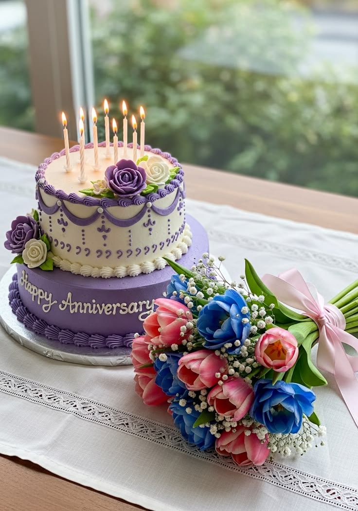 Elegant anniversary cake with candles and flowers